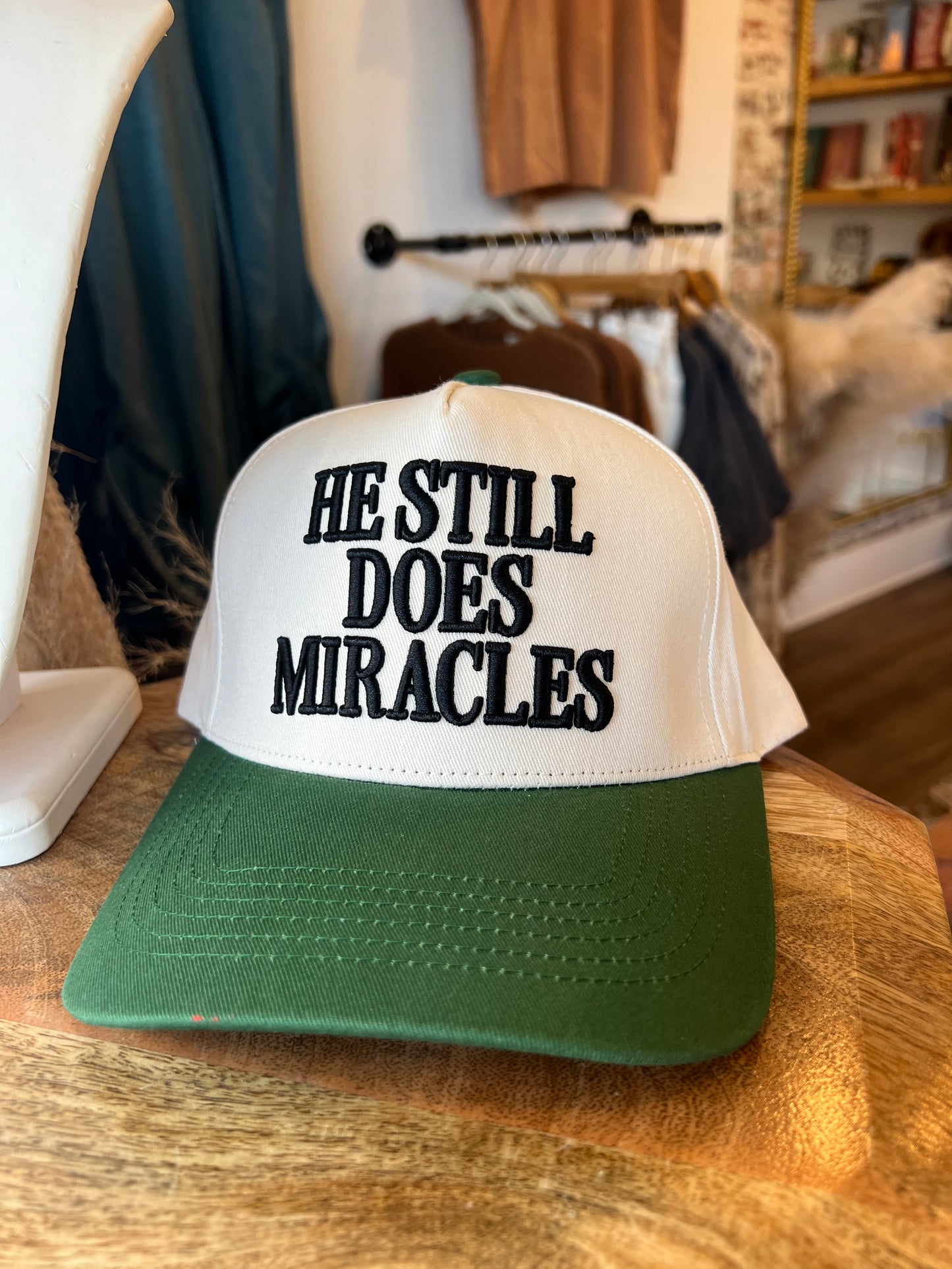 He Still Does Miracles Trucker Hat